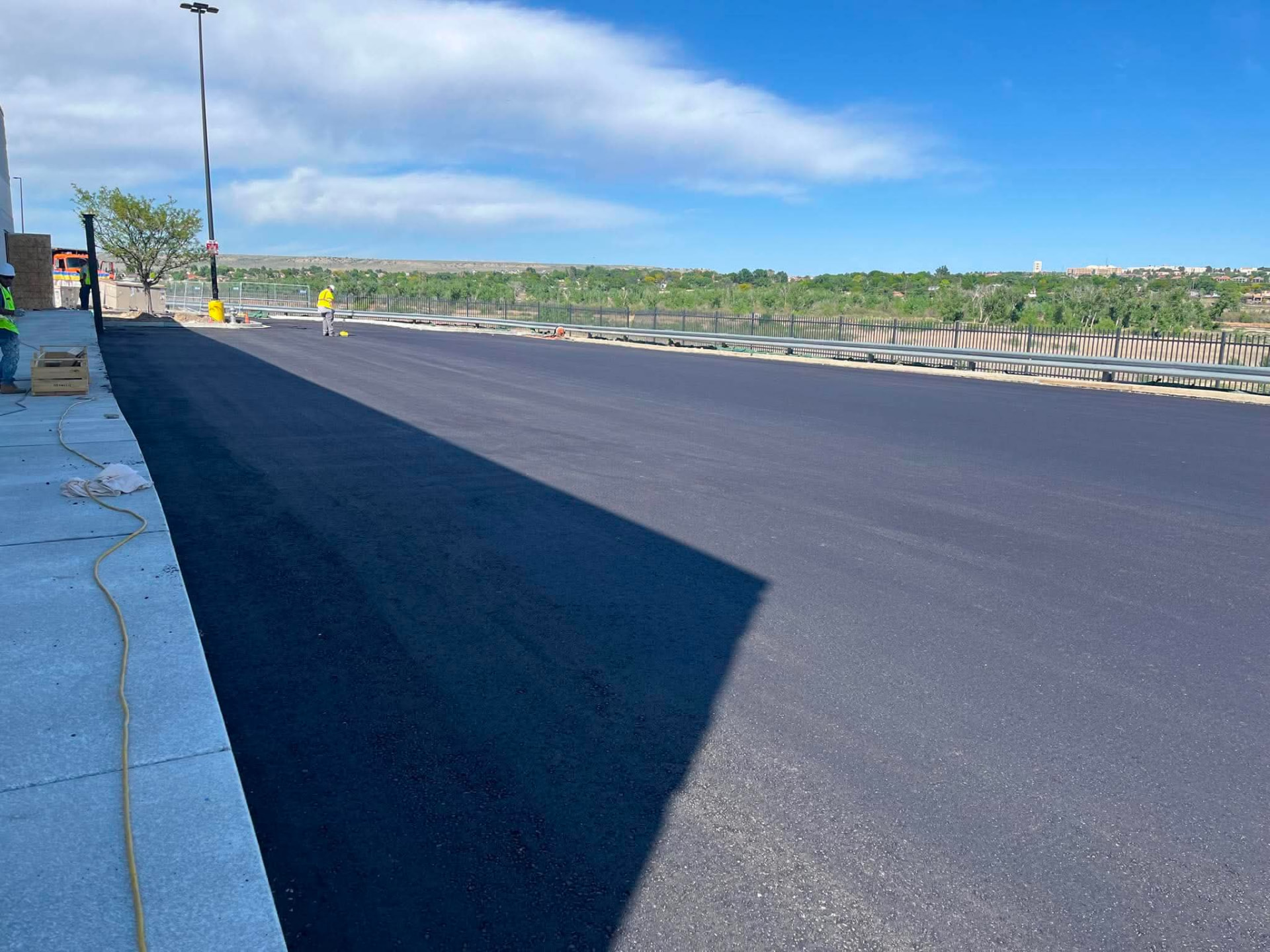 Freshly placed full-depth asphalt paving on a Colorado commercial site